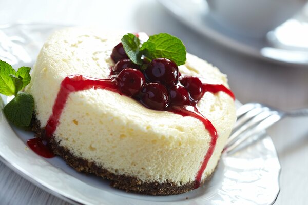 Sponge cake dessert with a cherry in a plate