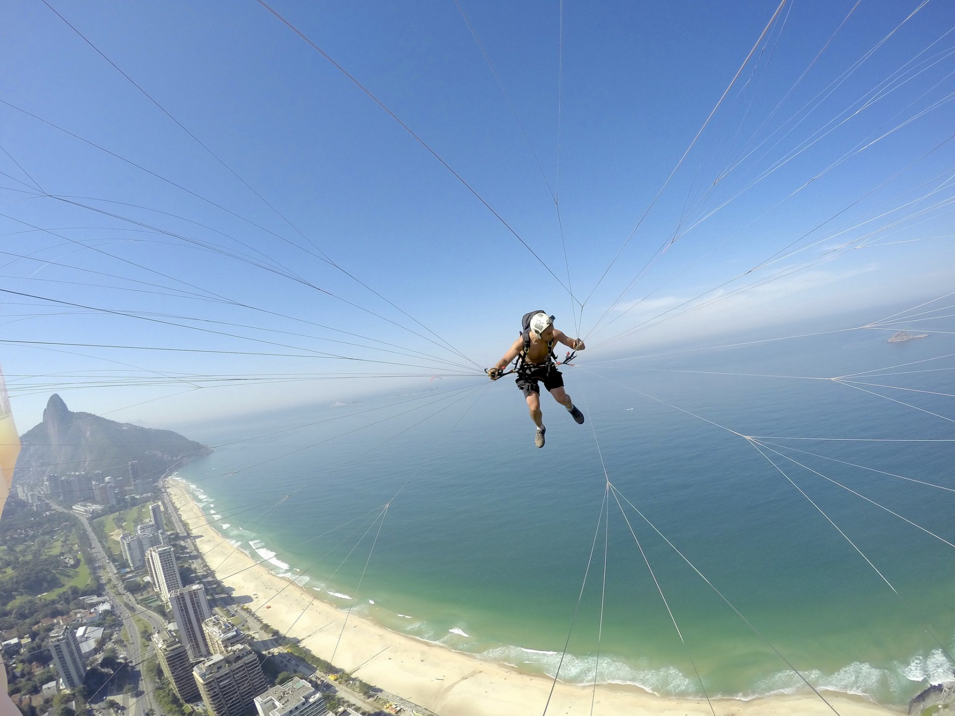 paralotniarstwo paralotnia pilot kamera kask wątek plaża morze wysepka horyzont niebo brazylia rio de janeiro sporty ekstremalne