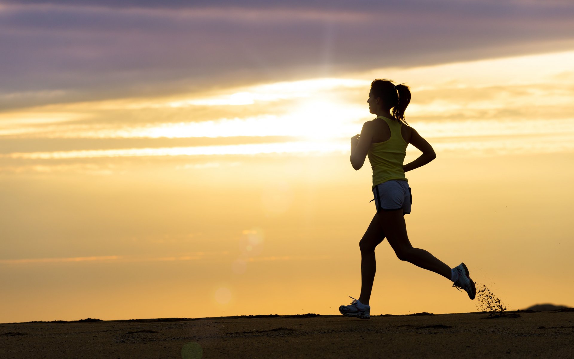 athlete running dirt sand