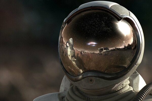 A man in a spacesuit with a reflection on his helmet