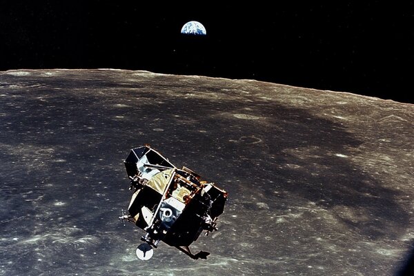 A spaceship is approaching the moon on the background of the earth