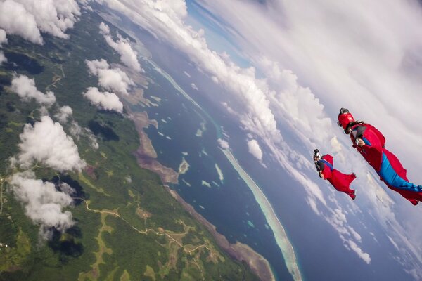 Wingsuit pilots soar in the clouds