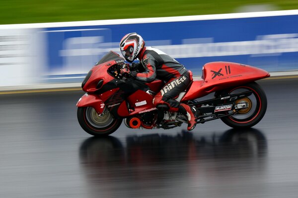 Red racing motorcycle on the track in motion