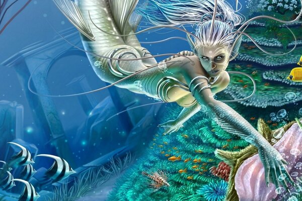 A mermaid swims at the bottom of the sea