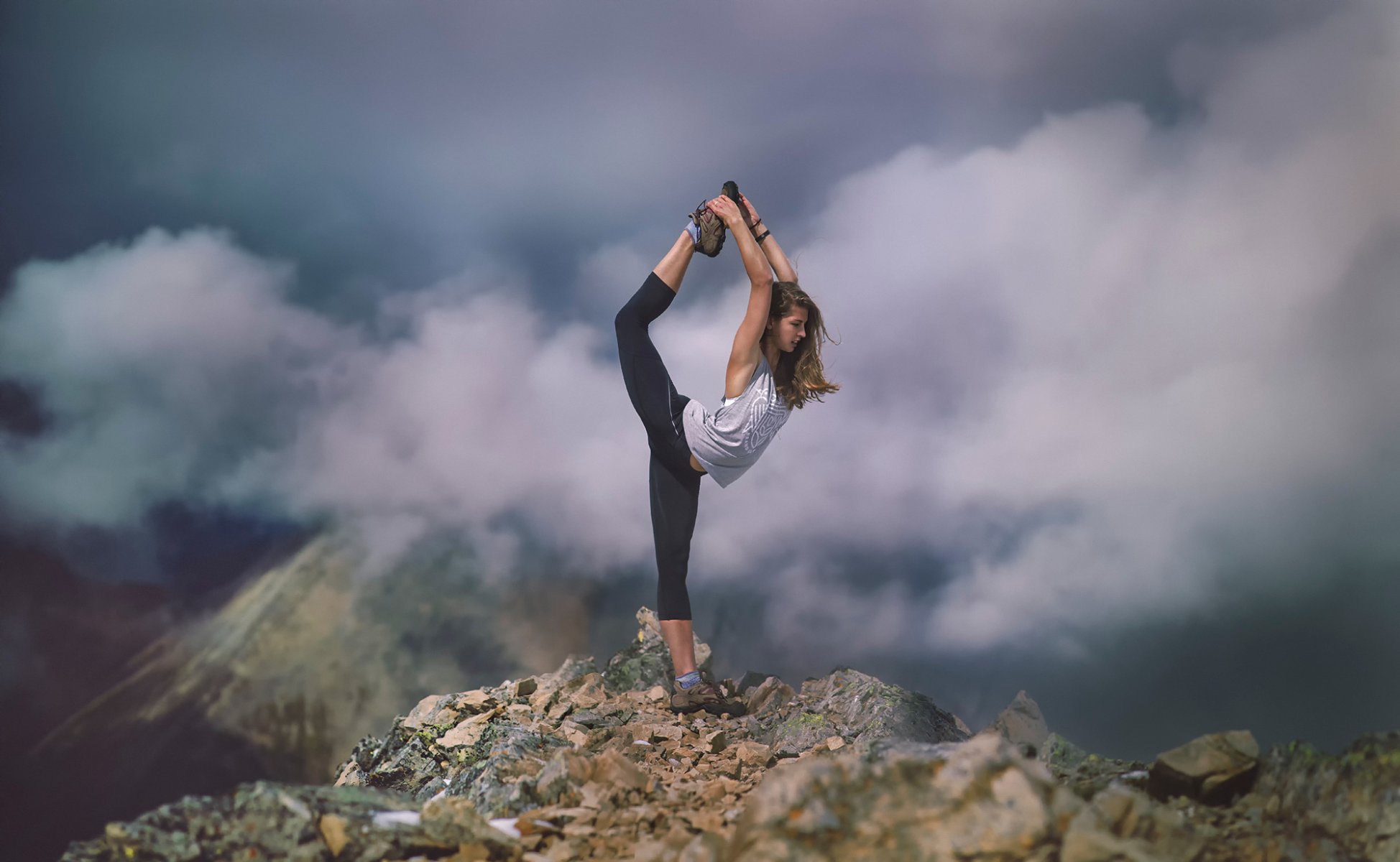 tretch girl athlete stretching clouds mountain