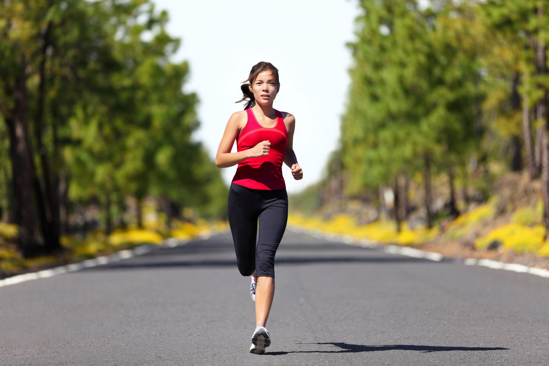 woman running sportswear street trees shade