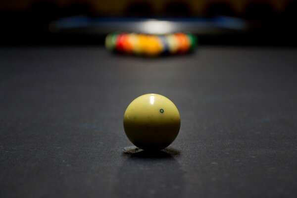 Billiard ball on the table in the foreground