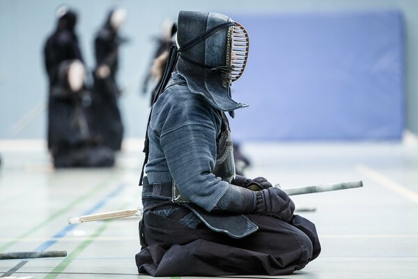 A kendo fighter in the same form is resting