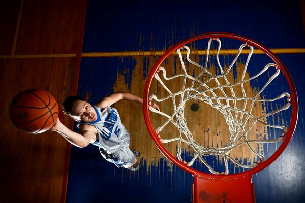 Basketball player throws the ball into the ring top view