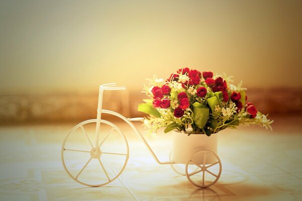 White bicycle with a bouquet of flowers