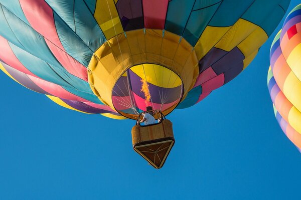 The balloon is flying in the sky