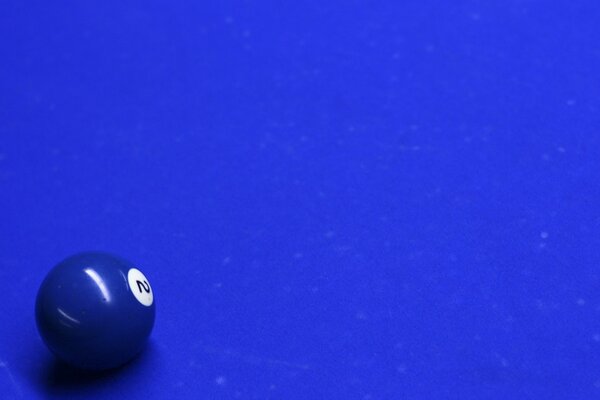 A blue ball on a blue billiard table