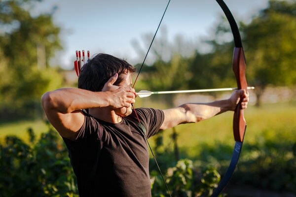 A man shoots an arrow. Bow and Arrow