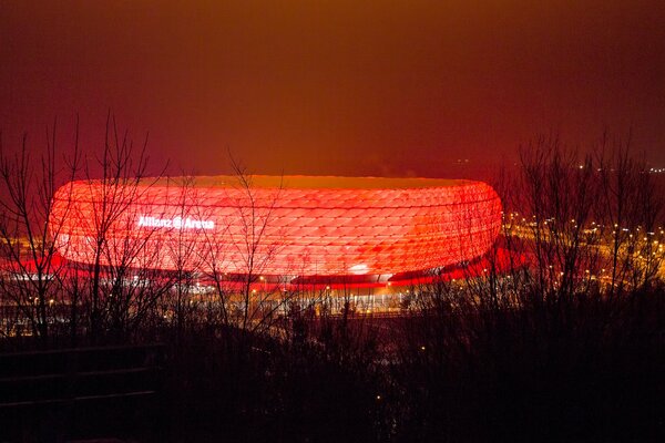 A glowing stadium at night. Red backlight