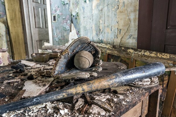 Baseball bat, glove and ball in a destroyed house