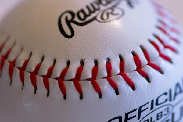 Stitching a white ball with red threads