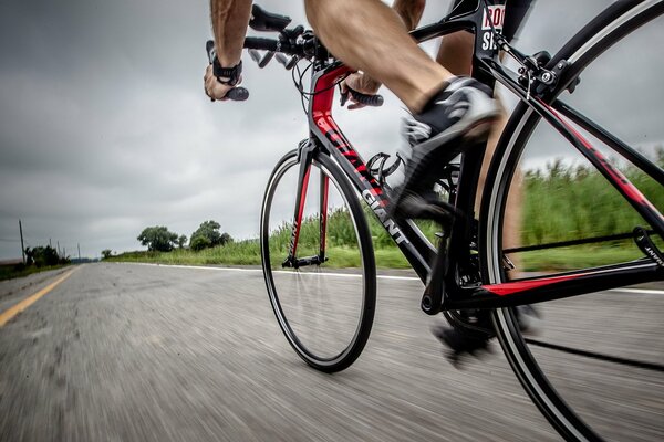 An athlete rides a bicycle on the road