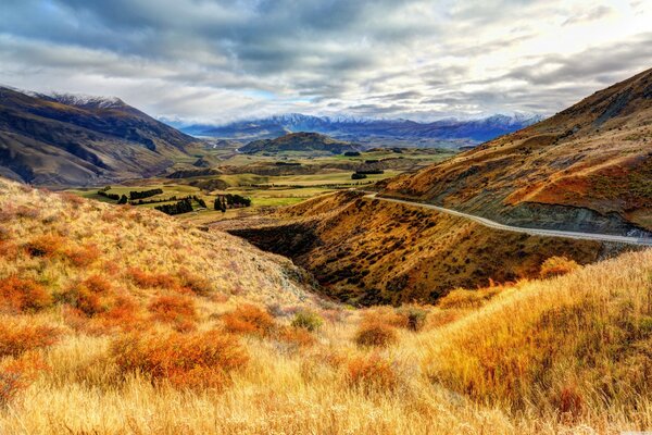 Long road, field and mountains