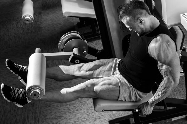 A muscular man is engaged in the gym