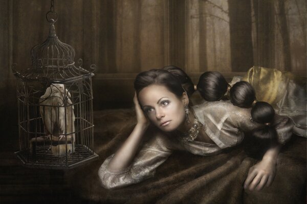 A girl and a white crow in a cage