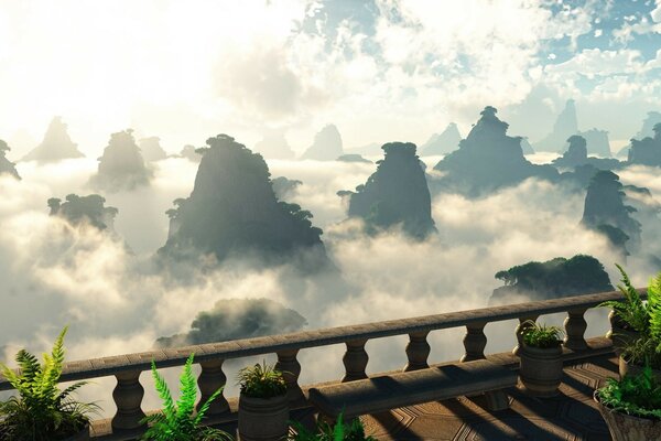 Railings over the precipice with rocks in the clouds