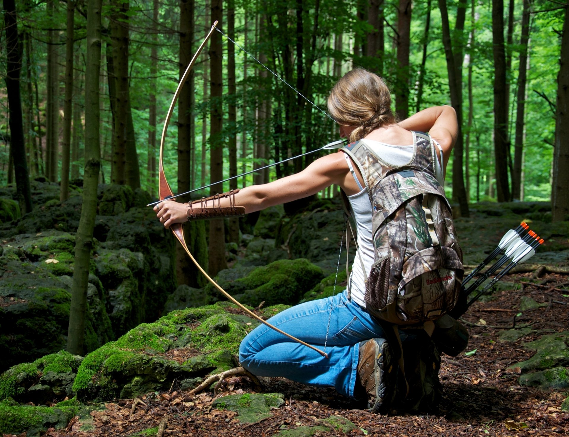 woman bowhunting archery pose