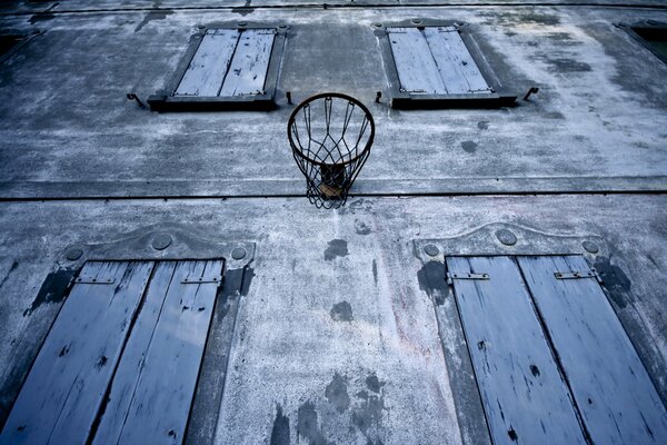 Basketball hoop on the wall of the house