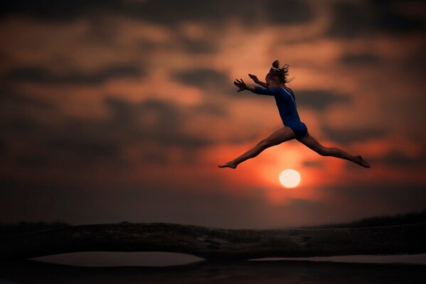 Gymnastic. a girl does exercises on a log