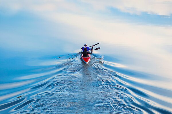 Two people are floating in a boat