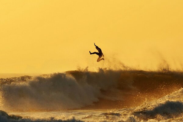 An exciting surfer at sunset