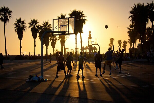 People play basketball on the beach