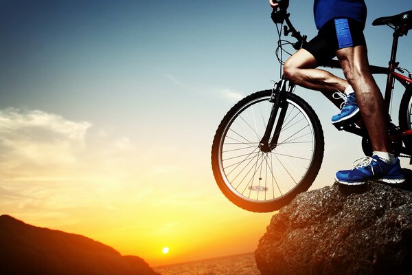 Ragazzo con una bicicletta in piedi su una montagna