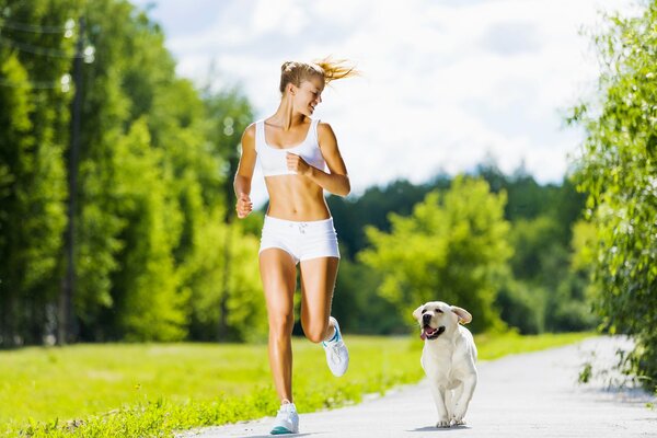 The girl goes in for sports together with her pet