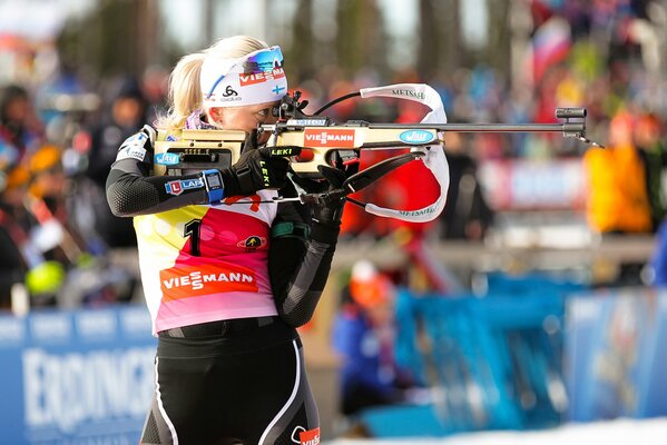 The biathlete is going to make a well-aimed shot