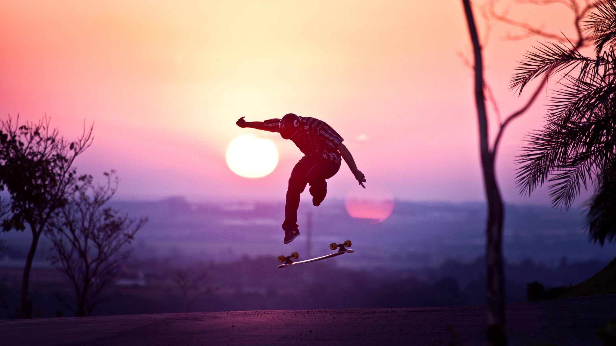 guy helmet skateboard jump sun sunset