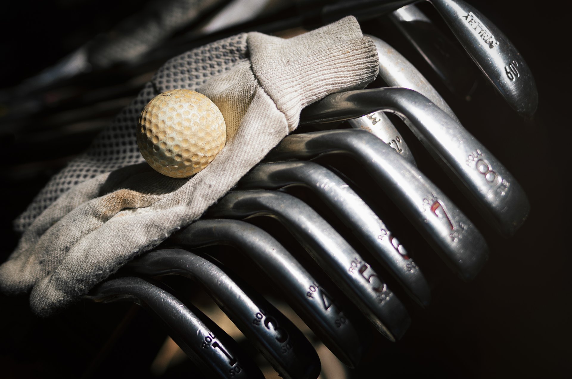 golf clubs ball glove close up