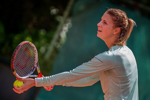 Luxembourg racket, a ball in the hand of a tennis player