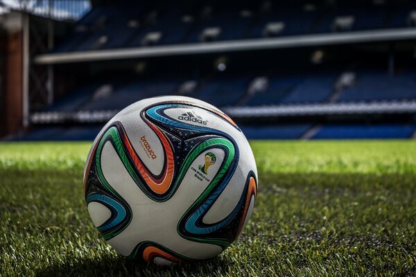 Soccer ball on the stadium and green lawn