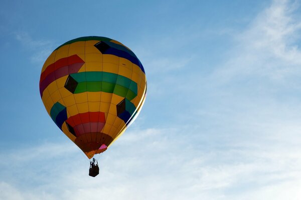 The balloon is flying through the sky