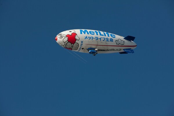 Airship balloon in the sky on a blue background