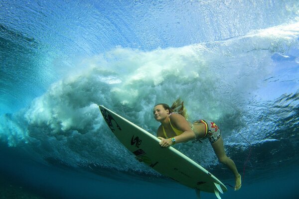 Surfer with a board under water