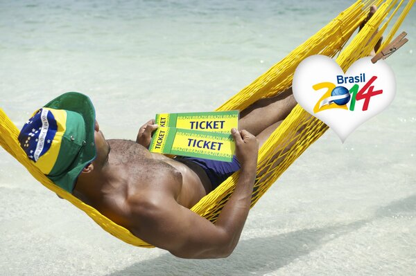 A man in a hammock holds tickets