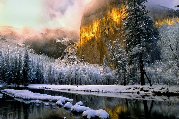 Golden Mountain on the shore of winter lake