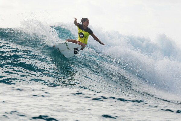 A surfer on a board floating on the waves