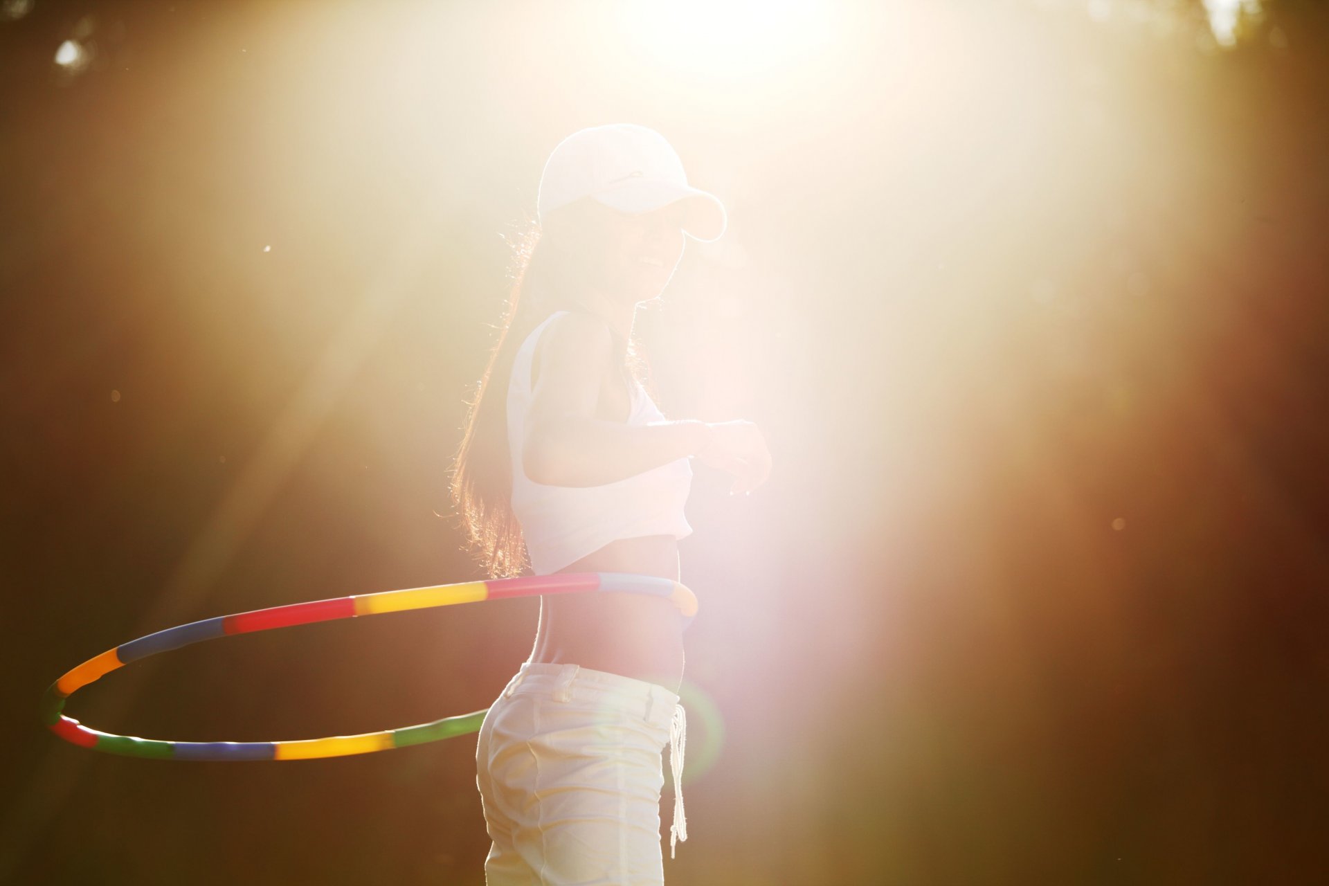 port girl hoop hula hoop figure movement rotation occupation cap baseball cap sun rays background wallpaper widescreen fullscreen widescreen