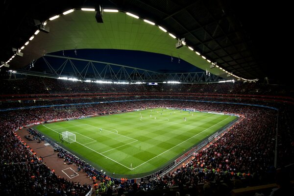 The stands of the huge stadium are packed with fans