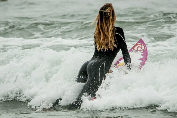 Sporty girl on a board in the sea