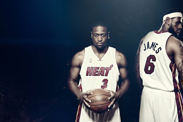 Dwyane Wade with the ball and next to LeBron James