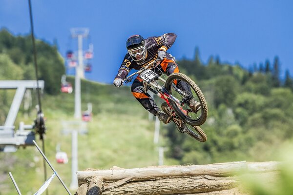 A cyclist jumps over an obstacle