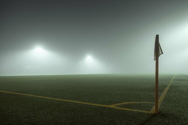 A football field and a flag in the fog